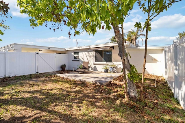 rear view of property featuring a patio