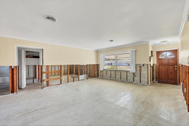 carpeted spare room featuring ornamental molding