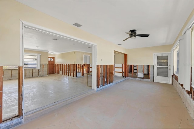 unfurnished room with ceiling fan and ornamental molding