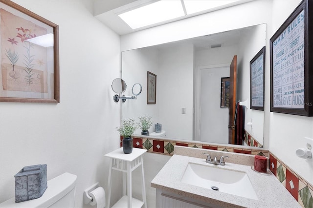 bathroom featuring vanity and toilet