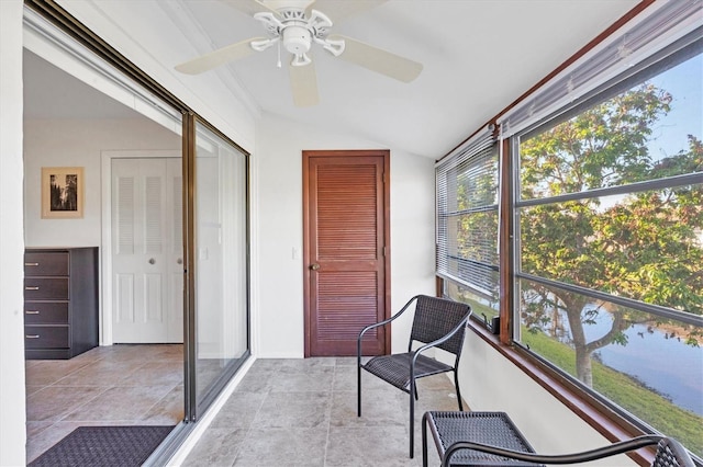 sunroom / solarium featuring ceiling fan, plenty of natural light, and vaulted ceiling