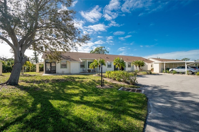 ranch-style home featuring a front yard