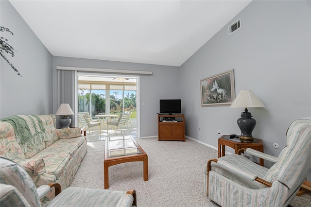 living room featuring light carpet and vaulted ceiling