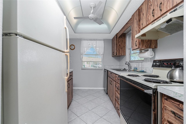 kitchen with light tile patterned flooring, white appliances, ceiling fan, and sink