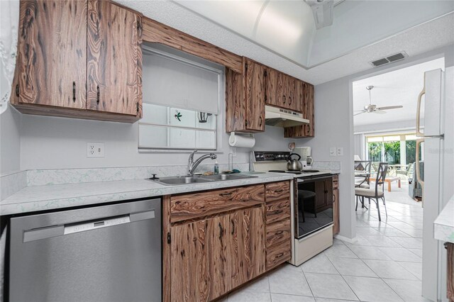 kitchen with ceiling fan, white appliances, sink, and light tile patterned floors