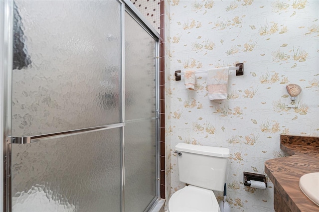 bathroom featuring walk in shower, vanity, and toilet