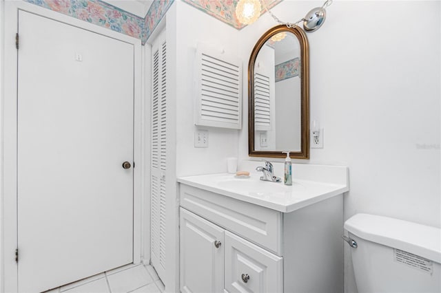 bathroom with tile patterned floors, vanity, and toilet