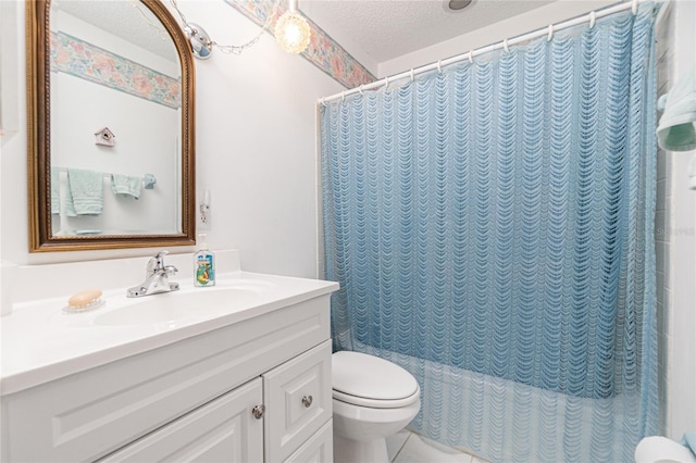 bathroom featuring vanity, a textured ceiling, and toilet