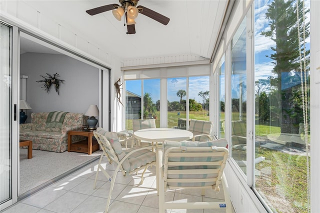 sunroom featuring ceiling fan and lofted ceiling