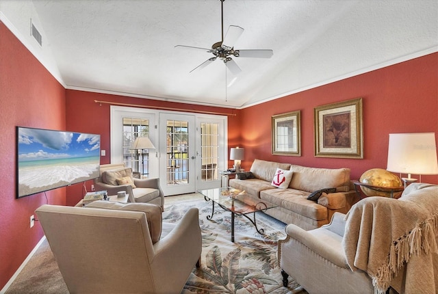 carpeted living room featuring lofted ceiling, french doors, ceiling fan, ornamental molding, and a textured ceiling