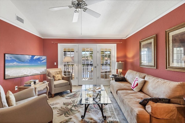 living room with lofted ceiling, french doors, crown molding, ceiling fan, and a textured ceiling