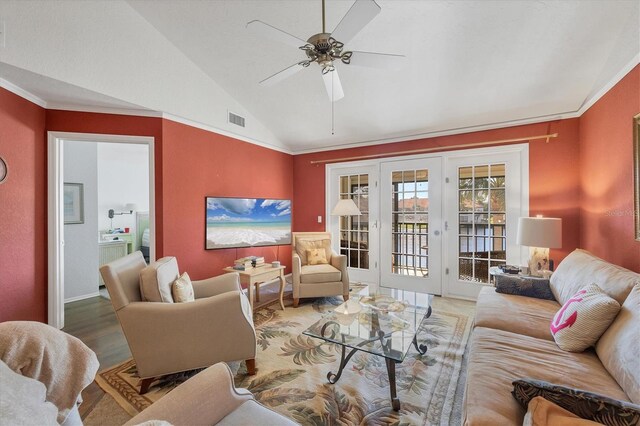 living room with ornamental molding, light hardwood / wood-style flooring, ceiling fan, and lofted ceiling