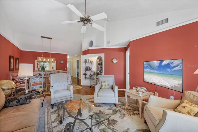 living room with ceiling fan, hardwood / wood-style floors, and high vaulted ceiling