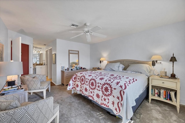 carpeted bedroom with ensuite bathroom and ceiling fan