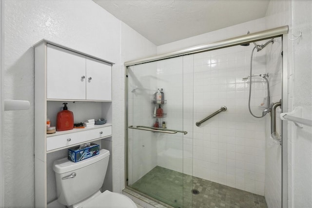 bathroom featuring toilet, a textured ceiling, and walk in shower