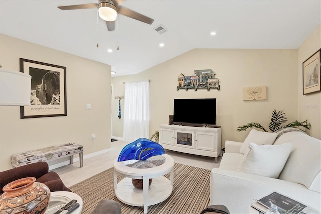 carpeted living room featuring ceiling fan and lofted ceiling