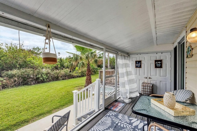 sunroom / solarium with vaulted ceiling