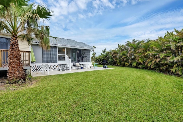 view of yard featuring a patio and a sunroom