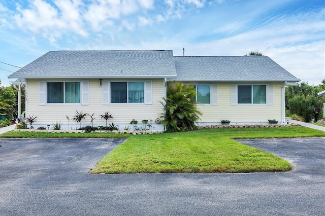 ranch-style home with a front yard