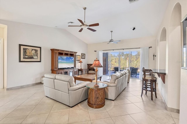 tiled living room featuring ceiling fan and high vaulted ceiling