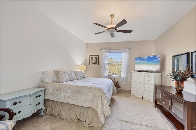 tiled bedroom featuring ceiling fan