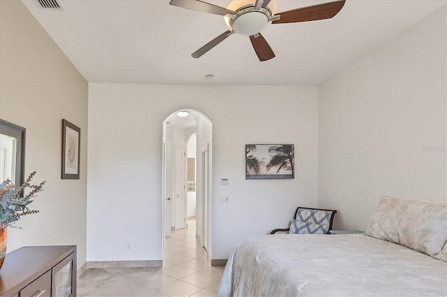 tiled bedroom featuring ceiling fan