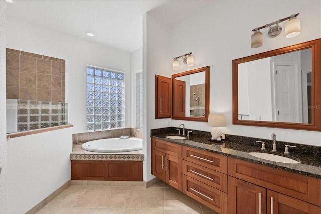 bathroom with tile patterned flooring, vanity, and plus walk in shower