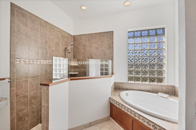 bathroom featuring shower with separate bathtub