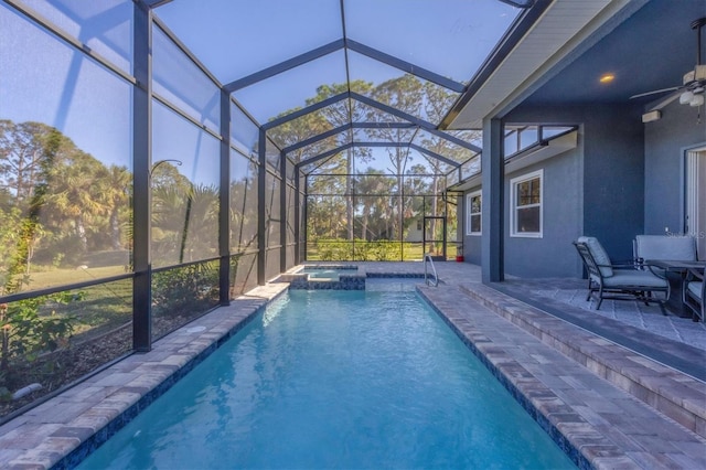 view of pool with ceiling fan, a lanai, an in ground hot tub, and a patio