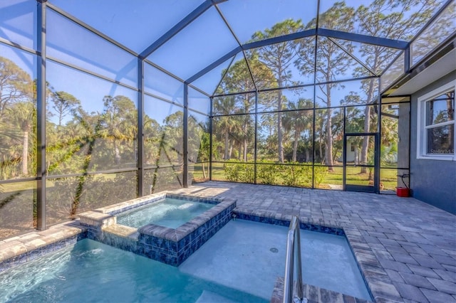 view of pool with a lanai, an in ground hot tub, and a patio