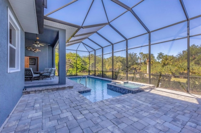 view of swimming pool with a lanai, an in ground hot tub, ceiling fan, and a patio