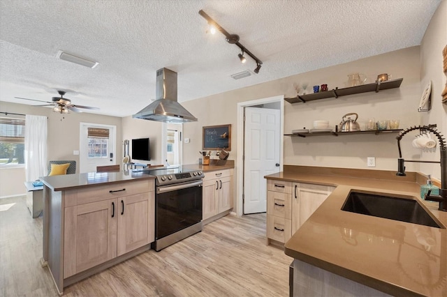 kitchen featuring stainless steel range with electric stovetop, extractor fan, sink, light brown cabinets, and light hardwood / wood-style floors