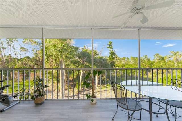 unfurnished sunroom with ceiling fan