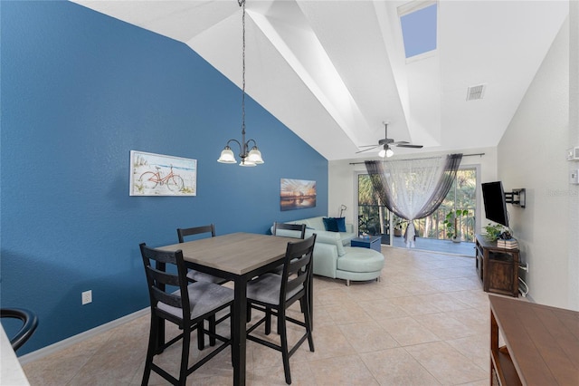 dining space with vaulted ceiling, light tile patterned floors, and ceiling fan with notable chandelier