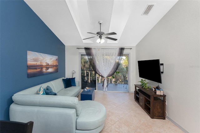 living room with ceiling fan, light tile patterned floors, and vaulted ceiling