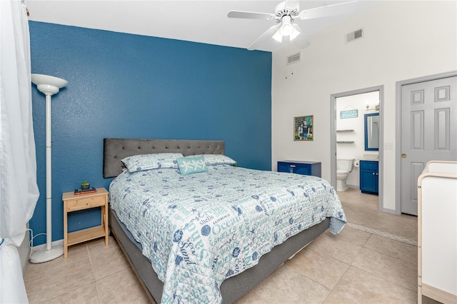 tiled bedroom with ensuite bathroom and ceiling fan