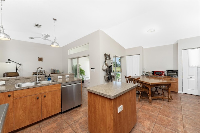 kitchen with a center island, stainless steel dishwasher, hanging light fixtures, and sink