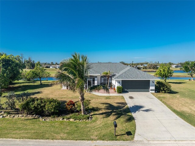 ranch-style home featuring a water view, a front yard, and a garage