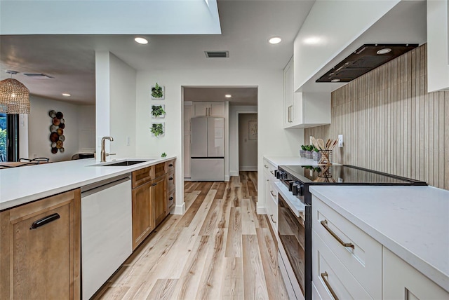 kitchen featuring electric range oven, stainless steel dishwasher, white fridge, white cabinets, and custom exhaust hood