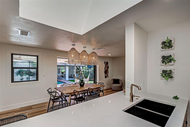 kitchen featuring hardwood / wood-style floors, plenty of natural light, and sink