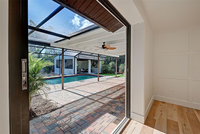 view of swimming pool with ceiling fan and a skylight