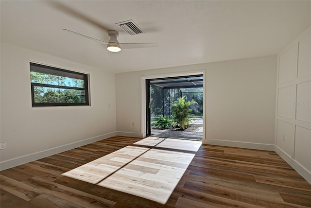 foyer with ceiling fan and wood-type flooring