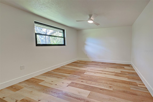 unfurnished room featuring ceiling fan and light wood-type flooring