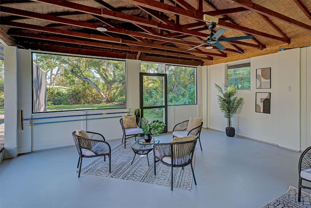 sunroom / solarium featuring vaulted ceiling with beams and ceiling fan