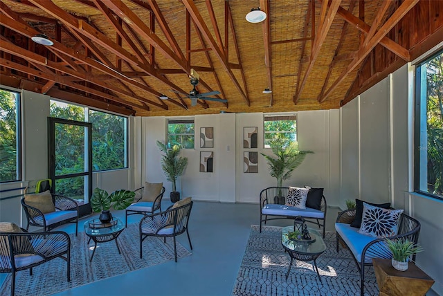 sunroom featuring ceiling fan, a healthy amount of sunlight, and lofted ceiling