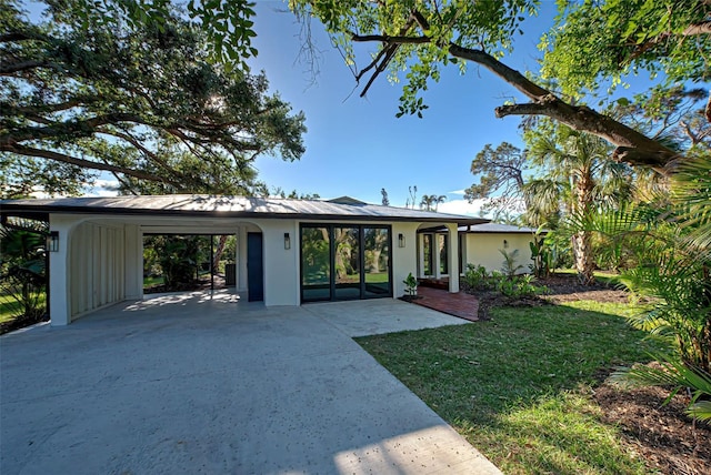 ranch-style house with a front yard and a carport