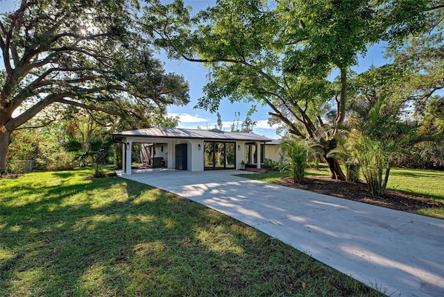 ranch-style house with a front yard and a carport