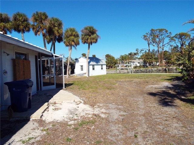 view of yard featuring a lanai and an outdoor structure