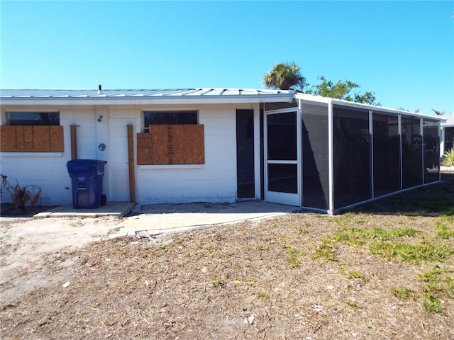 rear view of house with a sunroom