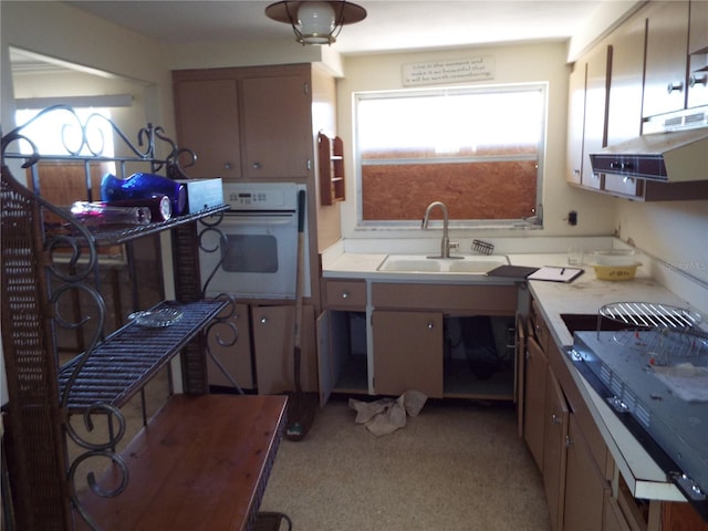 kitchen featuring white oven, sink, extractor fan, and cooktop